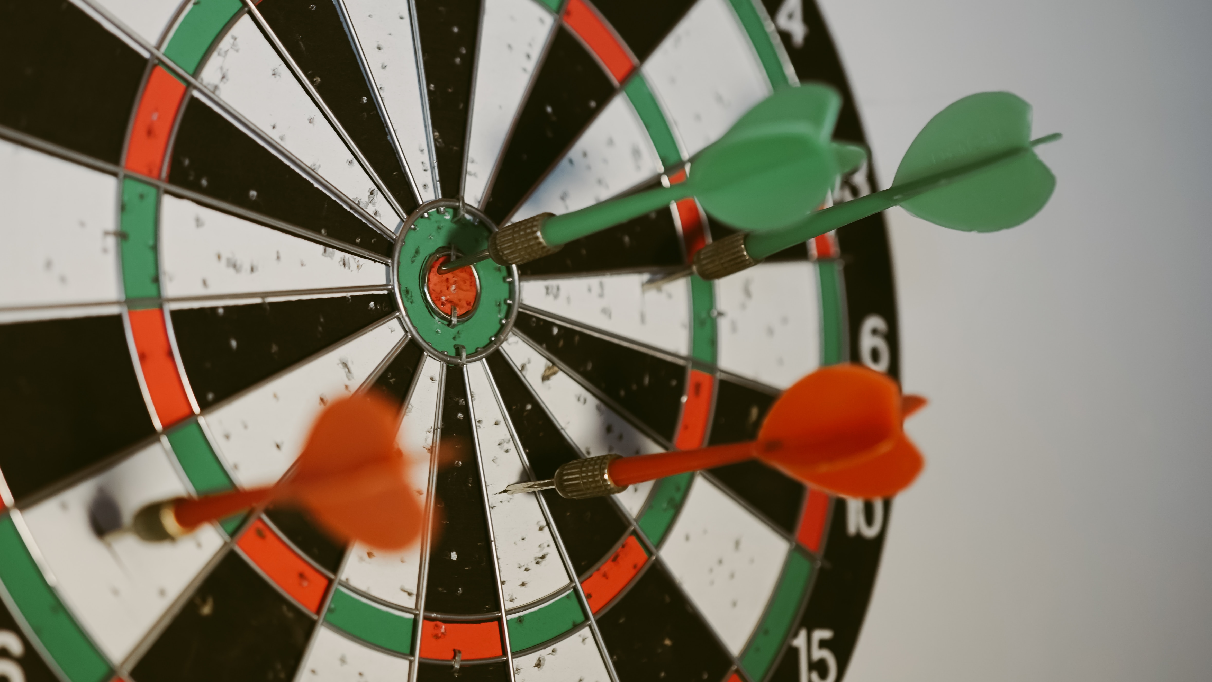 red and green darts on a dart board